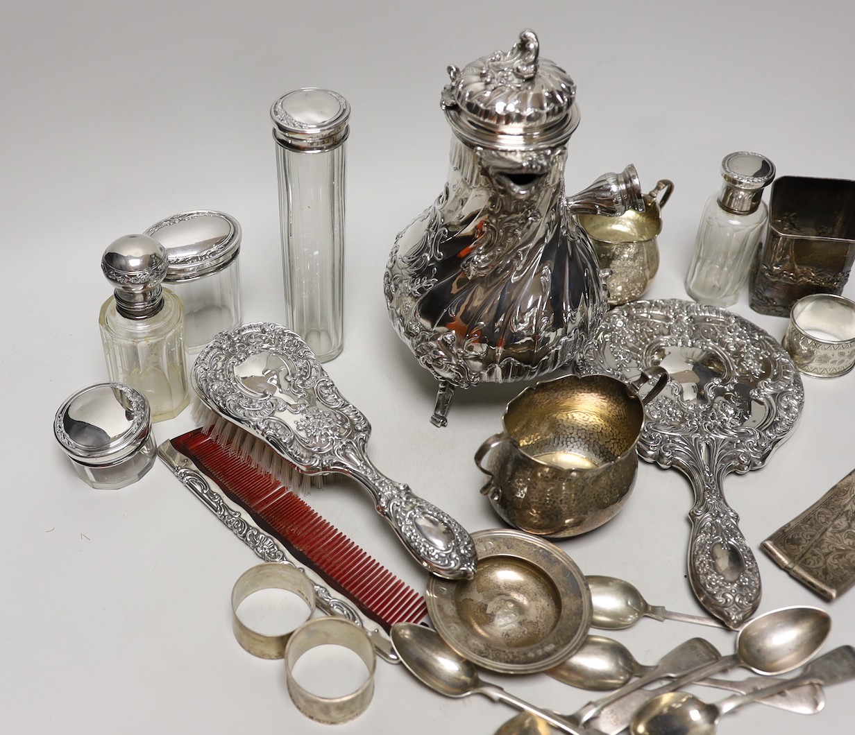 A late 19th/early 20th century French white metal coffee or chocolate pot (lacking handle), gross 21.5oz, a silver cream jug and sugar bowl, five French white metal mounted toilet jars, three silver napkin rings, a silve